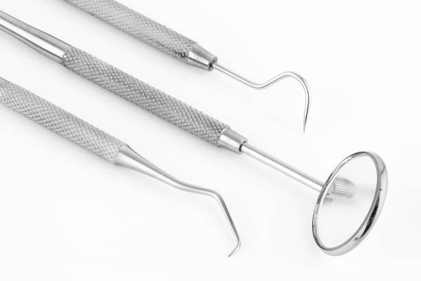 istock Dentist's tools inclined on a white background 1271358592