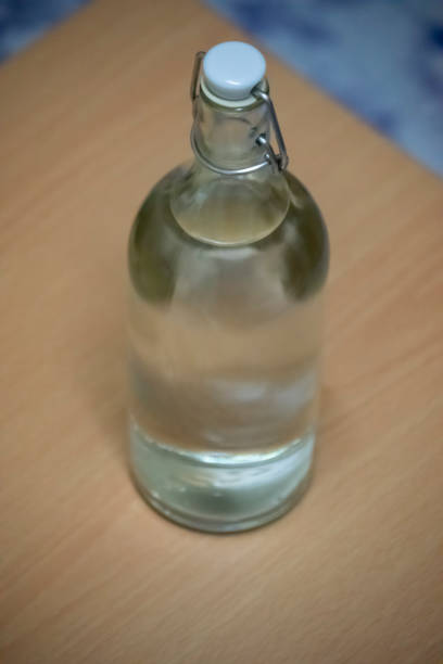 istock a glass bottle filled with water on a table 1271359761