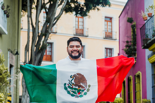 Mexican man with flag in mexican independence day in Mexico