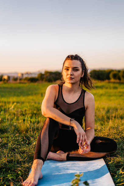 istock Woman resting after doing yoga on meadow 1271369564
