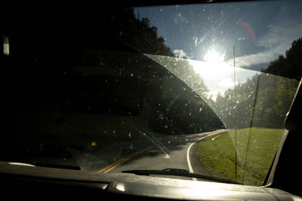 istock Dirty windsheild with sunshine on mountain road 1271371197
