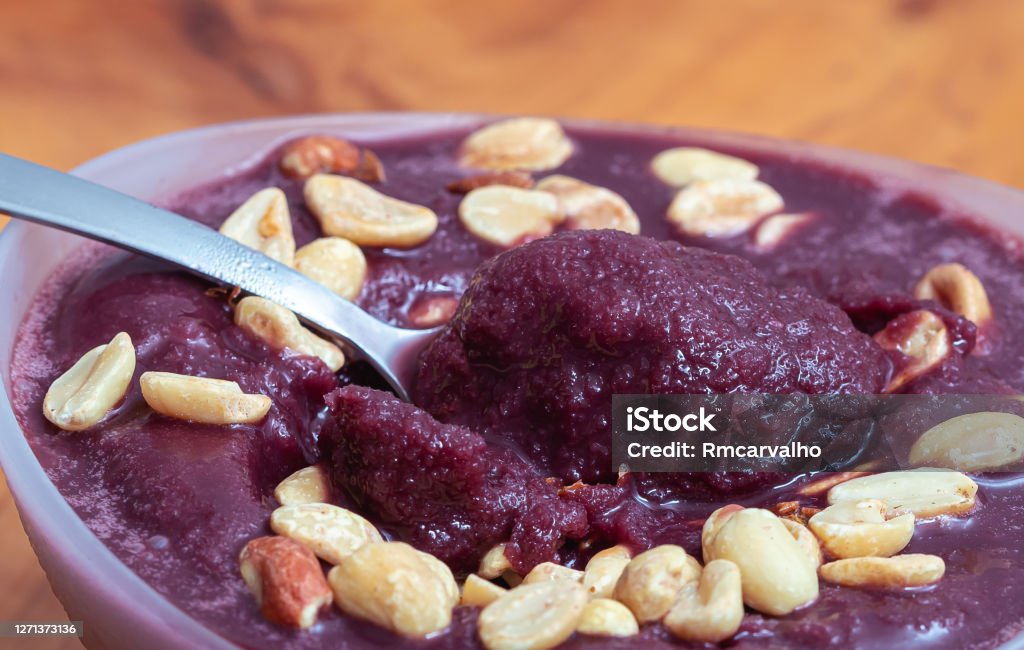 frozen acai with peanuts served in a bowl. Frozen açai ( açaí ). This version of açai is a more natural alteration of traditional açaí from the Amazon. Frozen açaí is often mixed with guaraná and banana syrup. Acai Stock Photo