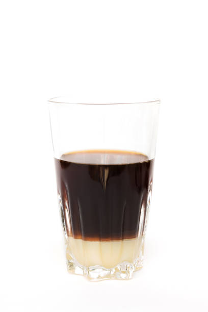 istock Dripping coffee with condensed milk at the bottom isolated on white background. 1271375590