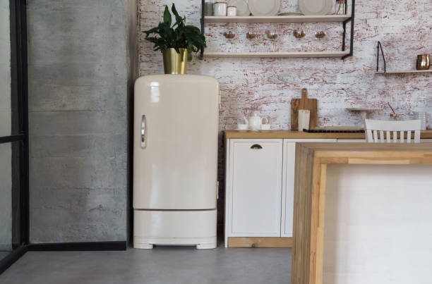 istock Retro old beige fridge in loft style wooden kitchen 1271377721