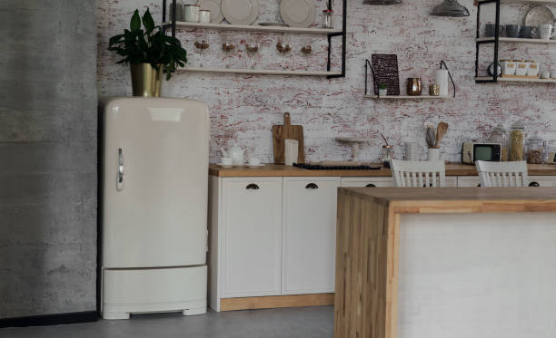istock Retro beige color fridge in loft kitchen with bricks wall 1271378282