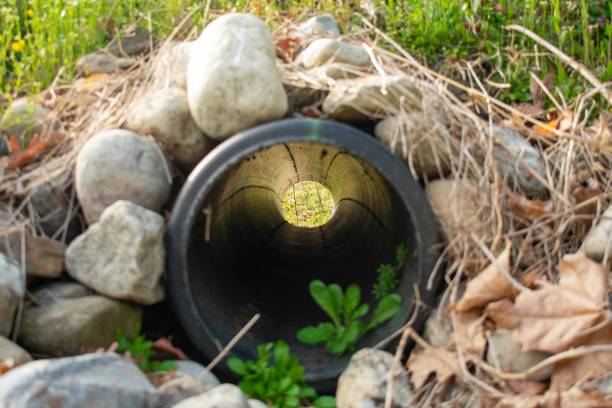 istock Looking Through a French Drain With a Black Pipe and Rocks Surrounded it 1271379011