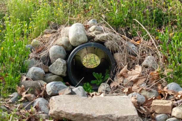 istock Looking Through a French Drain With a Black Pipe and Rocks Surrounded it 1271379033