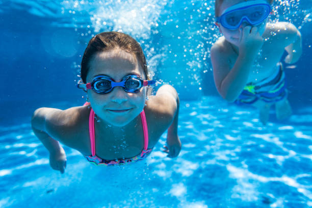 istock Children playing in the pool 1271381002