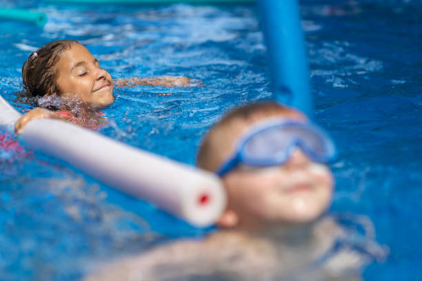 istock Children playing in the pool 1271381090