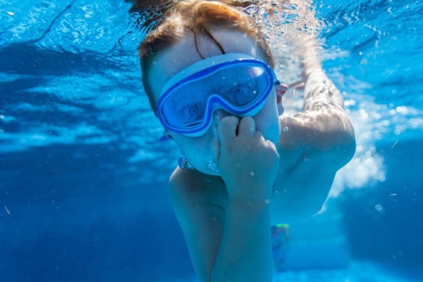 istock Children playing in the pool 1271381205