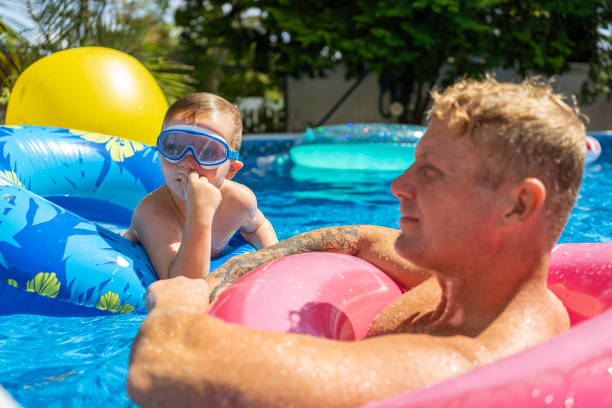 istock Children playing in the pool 1271381279