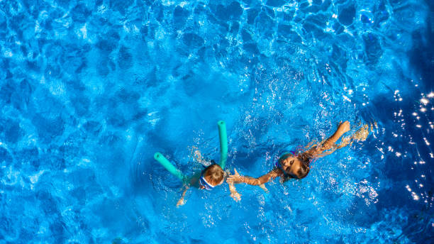istock Children playing in the pool 1271381303