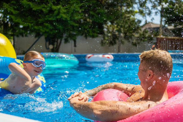 istock Children playing in the pool 1271381347