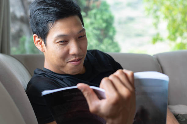 istock Man reading a book at home, relaxing. Hobbies and leisure. 1271381456