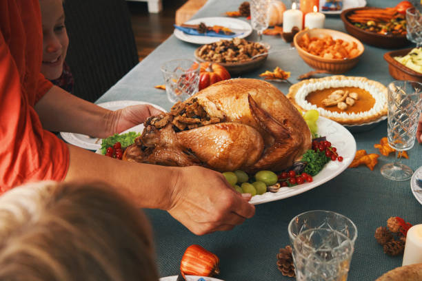 istock Family Having Traditional Holiday Stuffed Turkey Dinner 1271383047