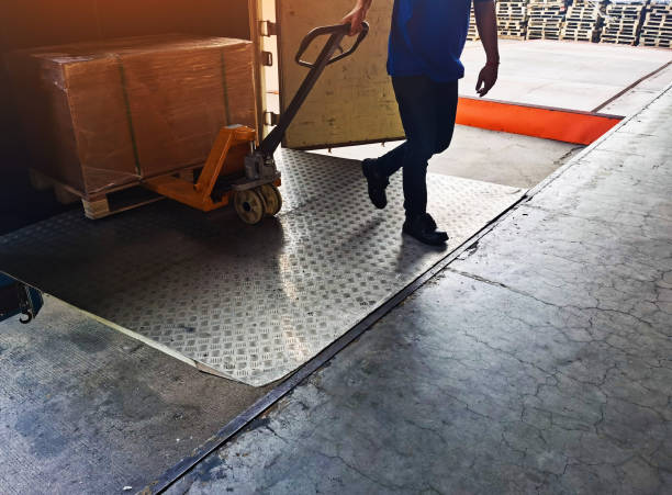 Blue collar workers are working at warehouse. Logistics, transportation.