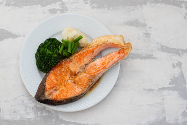 istock fried salmon trout with boiled vegetables on the dish 1271386959