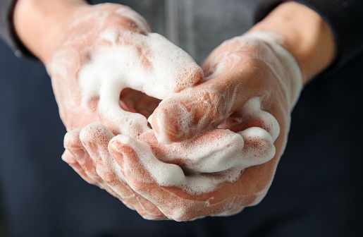 Hands with foam, close-up. Skin disinfection. Taking care of hand hygiene.