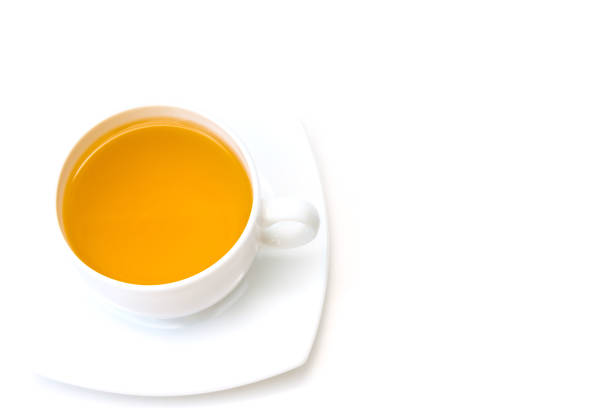istock White porcelain cup with freshly brewed green tea isolated on white background. 1271390175