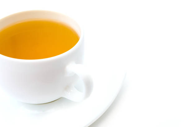 istock White porcelain cup with freshly brewed green tea isolated on white background. 1271390182