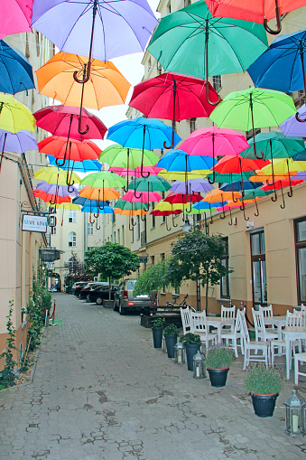 Lodz / Poland. 01 July 2019: Colored umbrellas hanging at the top. Set of different umbrellas. Local landmark. Cafe decoration in Lodz