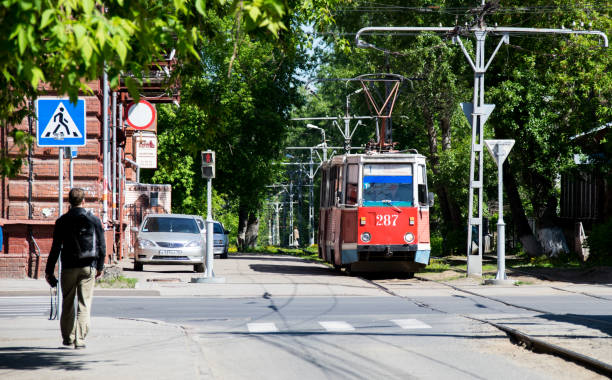 Tomsk, Russia - June 4, 2016: Tram goes through a green alley. Tram goes through a green alley in Tomsk city june 1 stock pictures, royalty-free photos & images