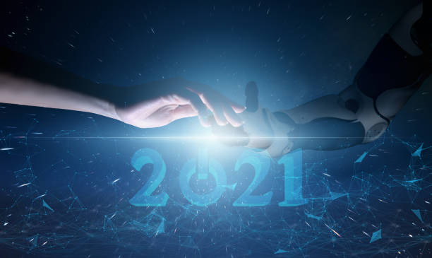 istock concept of human interaction with future technologies and robotics. Accompanying a person with a cyborg in the new year 2021 and automation of life 1271391665