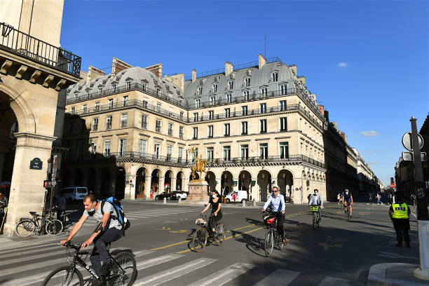 People cycling on rue de Rivoli, Paris, France. Paris, France-09 08 2020:People cycling on the cycle paths of the rue de Rivoli in Paris , France. place des pyramides stock pictures, royalty-free photos & images