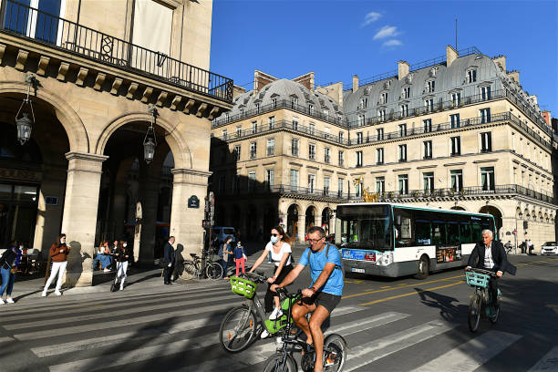 People cycling on rue de Rivoli, Paris, France. Paris, France-09 08 2020:People cycling on the cycle paths of the rue de Rivoli in Paris, France. place des pyramides stock pictures, royalty-free photos & images