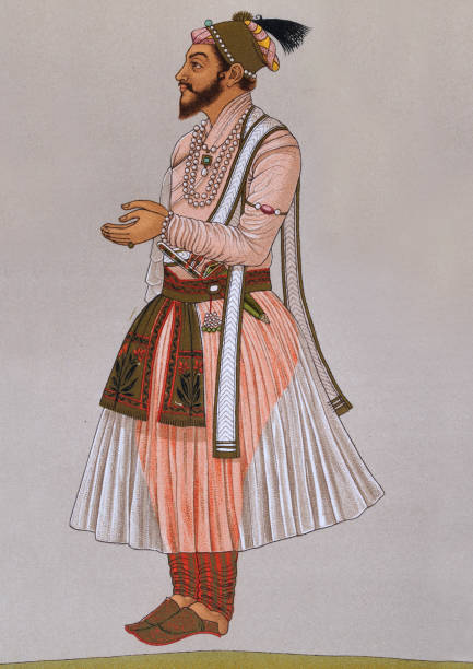 Costume of Indian Rajput, Traditional fashions India, 19th Century Vintage illustration of the Costume of a Indian Rajput (son of a king)  a large multi-component cluster of castes, kin bodies, and local groups, sharing social status and ideology of genealogical descent originating from the Indian subcontinent. caste system stock illustrations