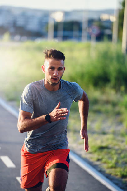 istock Sports man running fast outdoors on a race track 1271395444