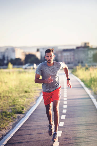 istock Sports man running fast outdoors on a race track 1271398747