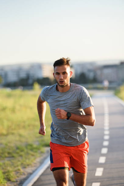 istock Sports man running fast outdoors on a race track 1271398902