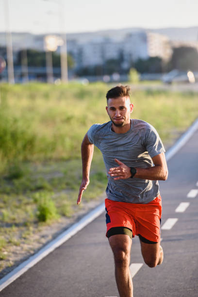 istock Sports man running fast outdoors on a race track 1271398906