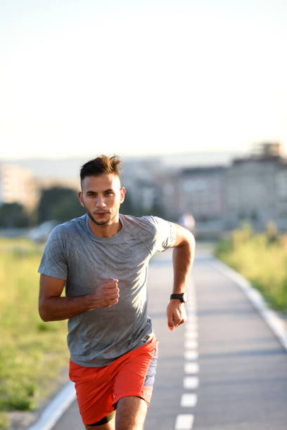 istock Sports man running fast outdoors on a race track 1271398909