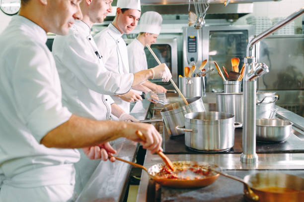 istock Chef cooking vegetables in wok pan. Shallow dof. 1271398957