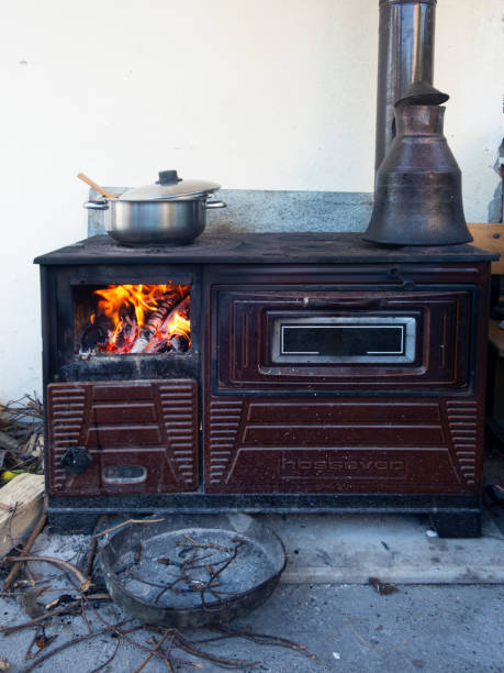 Village stove ready to cook with hazelnut tree is on fire