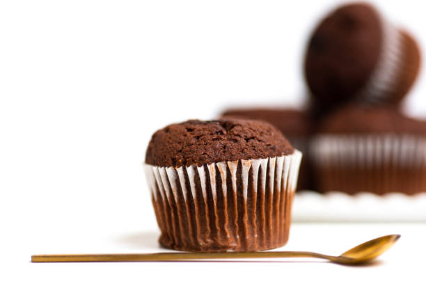 istock Chocolate muffin in a paper cupcake on white background 1271401476