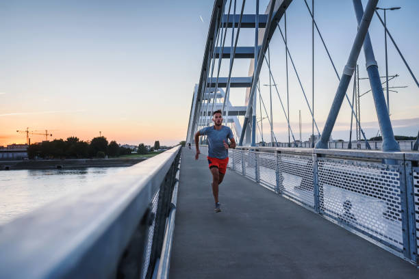 istock Sports man running fast outdoors on a race track 1271402328