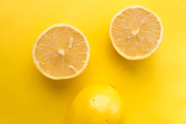 istock lemon isolated on yellow background 1271402394