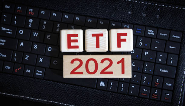 istock ETF 2021 concept. Wooden cubes on a black keyboard 1271404491