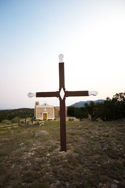 Golden, NM: The historic San Francisco de Asis Catholic Church. Golden is located 40 miles south of Santa Fe on the Turquoise Trail. Pale blue sky background and copy space.