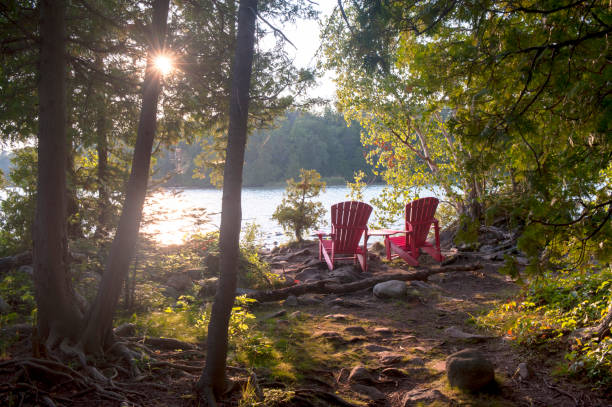 Red muskoka chairs at Bruce Peninsula National Park, Tobermory, Canada stock photo