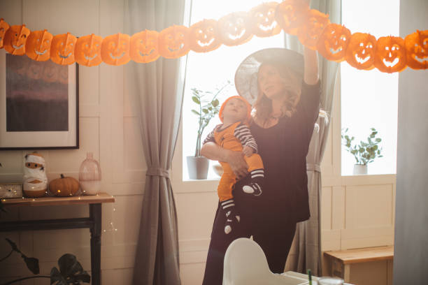 istock Decorating home for Halloween with baby 1271408694