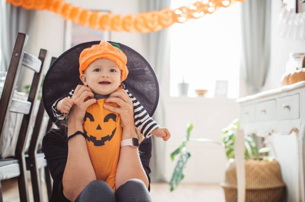 istock Mother and baby playing on Halloween 1271408757