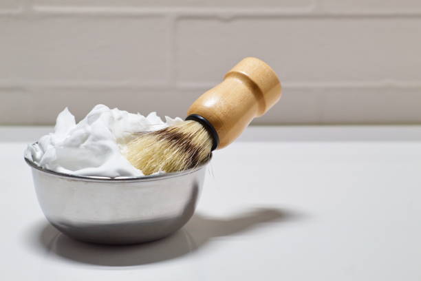 Bowl with shaving foam and brush on white background Bowl with shaving foam and brush on white background in bathroom for daily grooming shaving cream stock pictures, royalty-free photos & images