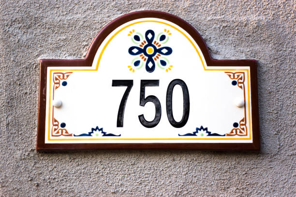 Colorful Ceramic Number 750 Street Address Tile Ceramic Number 750 Street Address; Colorful Mexican floral tiles on adobe wall. Shot in Santa Fe, NM. ceramic tile house numbers stock pictures, royalty-free photos & images