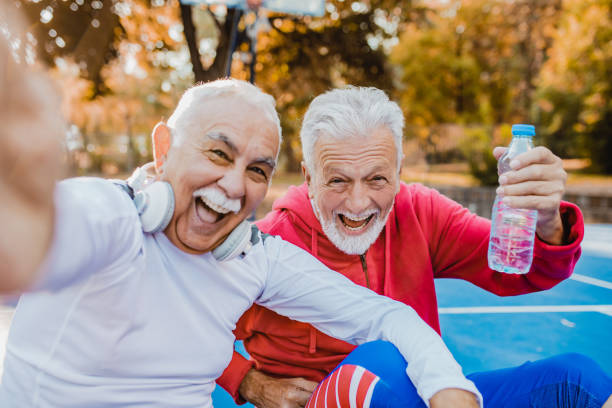 istock Two active senior men on basketball field taking selfie 1271412458