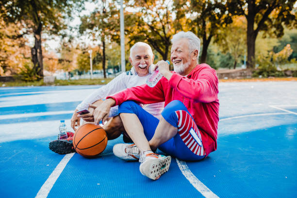 istock Two active senior men on basketball field taking a break from sport activity 1271412461