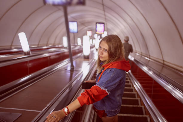 istock Woman on escalator at subway station. 1271413068